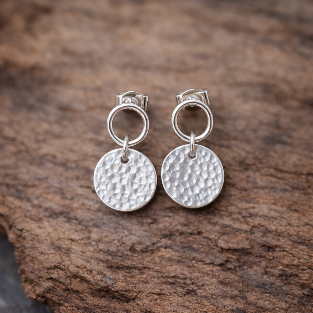 Sterling silver circle and hammered disc stud earrings.