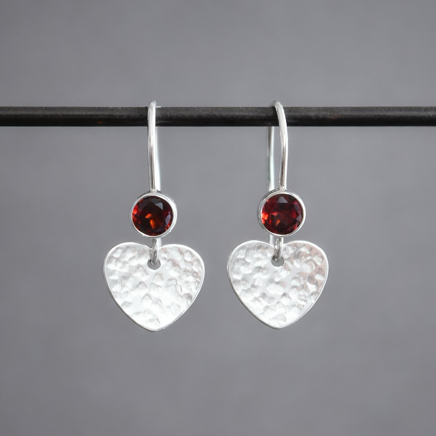 Garnet sterling silver heart dangle earrings.