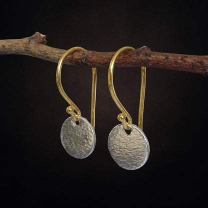 Hammered sterling silver disc and gold vermeil ear wire earrings.