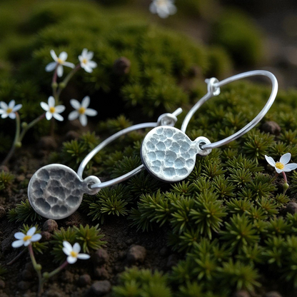 Hammered sterling silver disc charm hoop earrings.