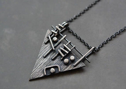 Sterling silver triangle necklace.