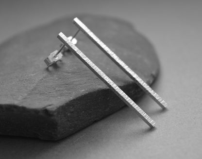 Hammered sterling silver bar stud earrings.