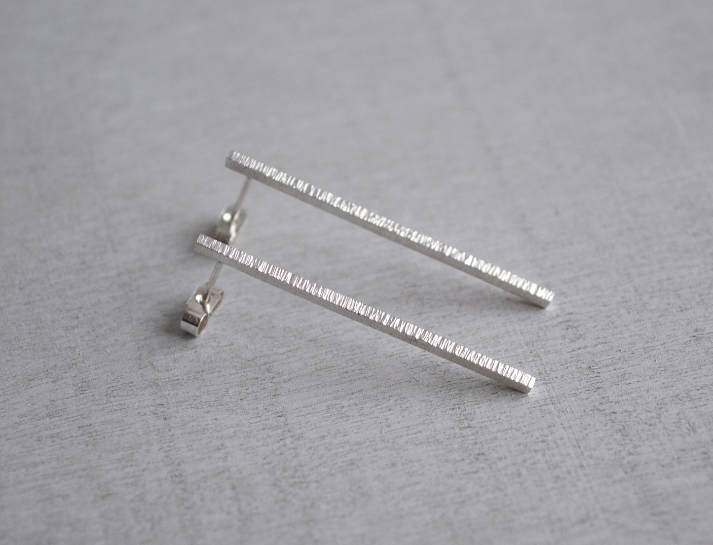Hammered sterling silver bar stud earrings.