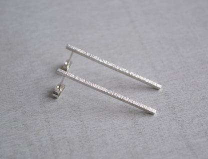 Hammered sterling silver bar stud earrings.
