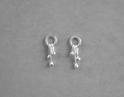 Sterling silver circle and droplets stud earrings.