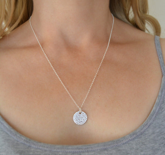 Minimalist sterling silver textured disc necklace.