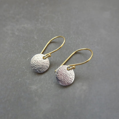 Hammered sterling silver disc and gold vermeil ear wire earrings.