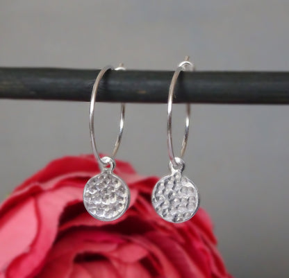 Small hammered sterling silver disc charm hoop earrings.