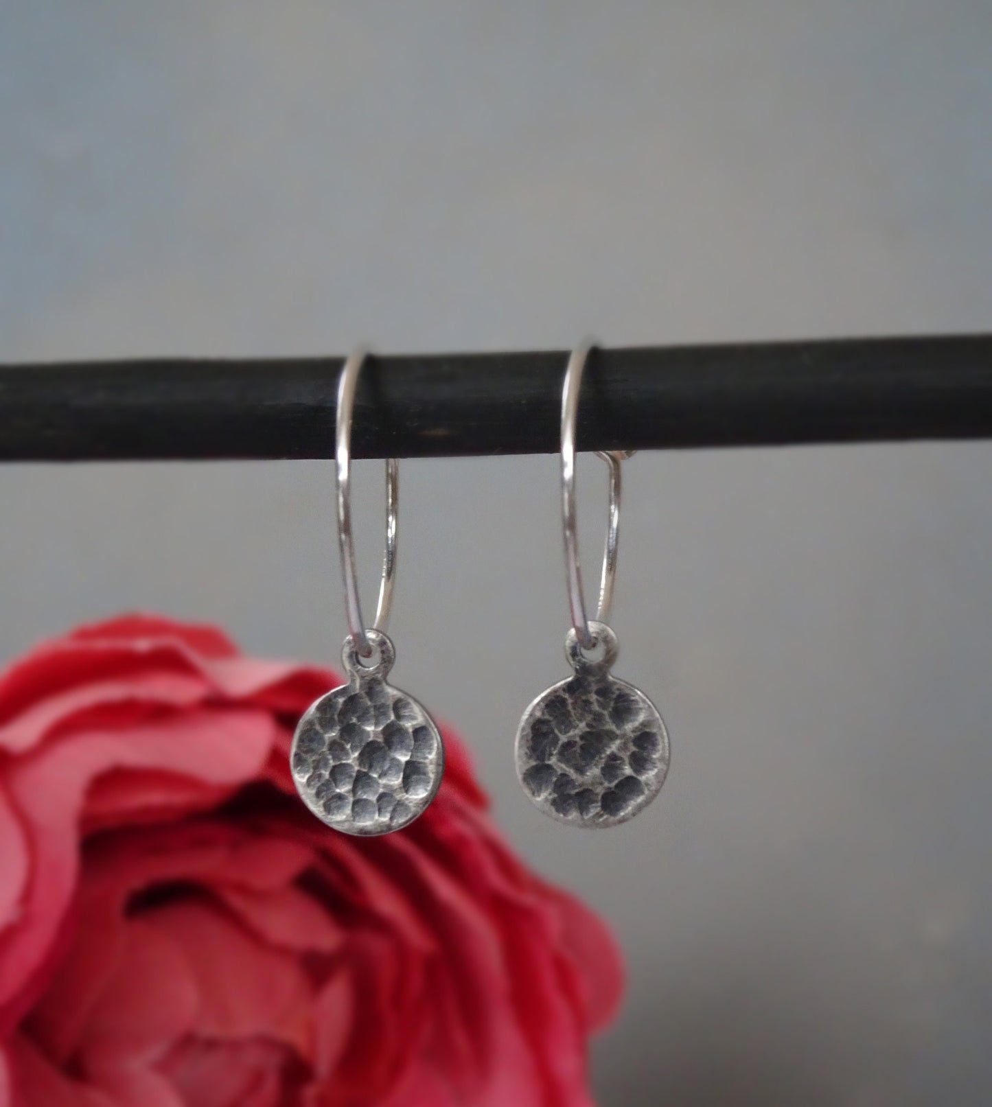 Small hammered sterling silver disc charm hoop earrings.