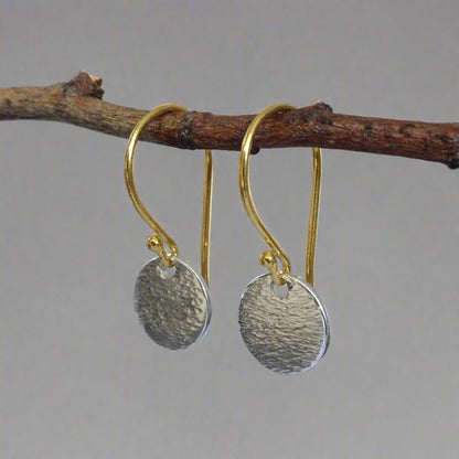 Hammered sterling silver disc and gold vermeil ear wire earrings.