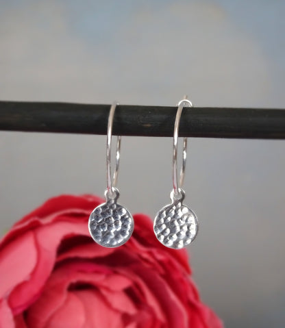Small hammered sterling silver disc charm hoop earrings.