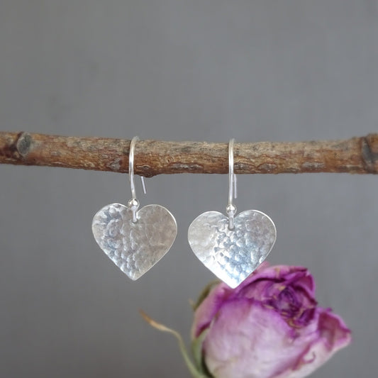 Sterling silver hammered heart dangle earrings.