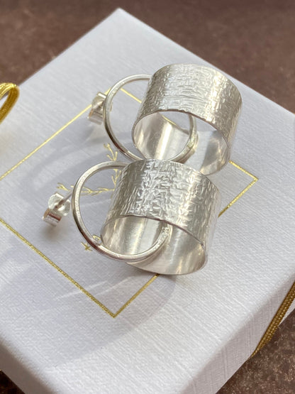 Sterling silver circle stud earrings.