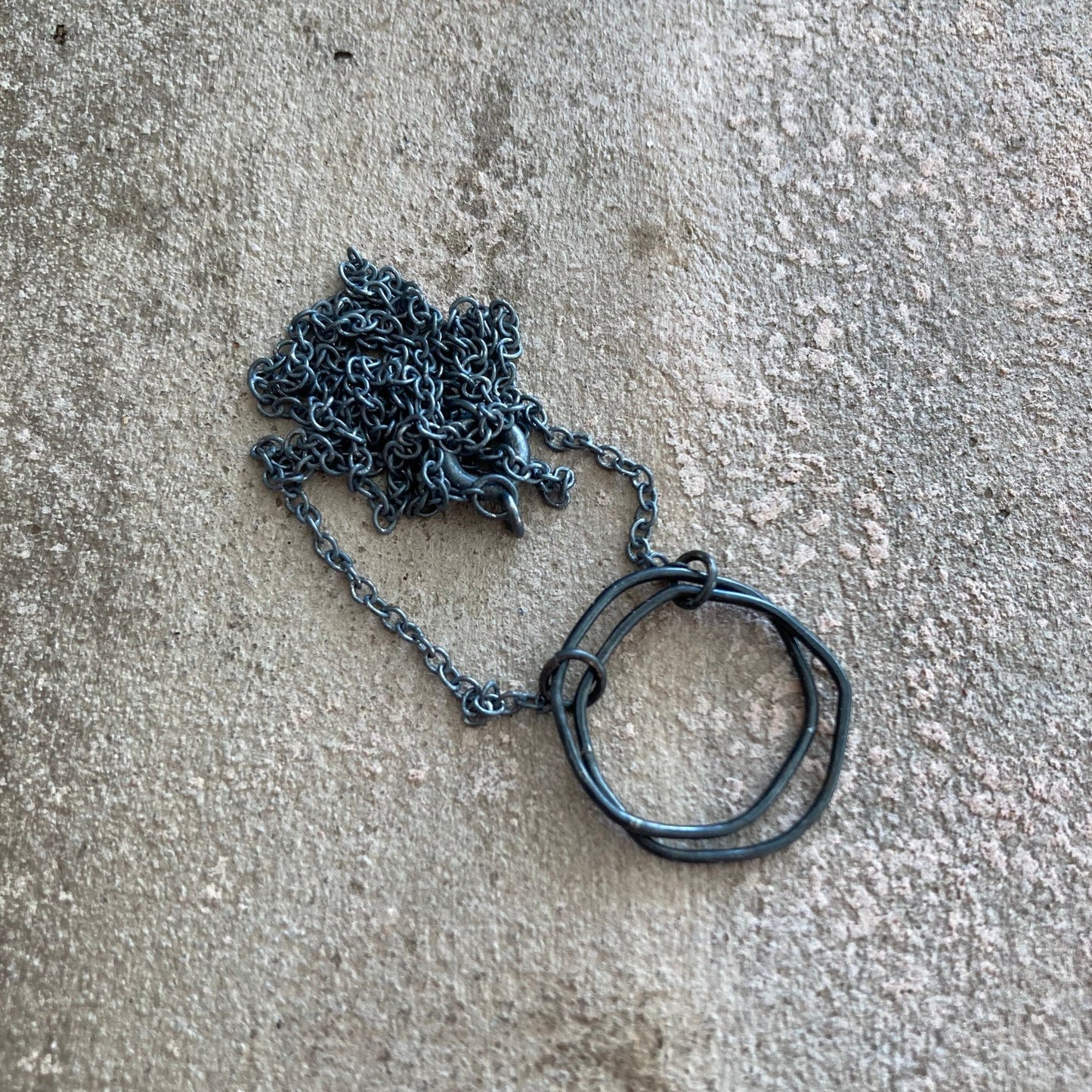 Oxidised sterling silver irregular two interlocking circle necklace.