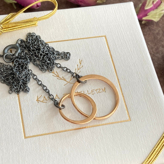 Double circles necklace. Rose gold circles and oxidised silver chain necklace