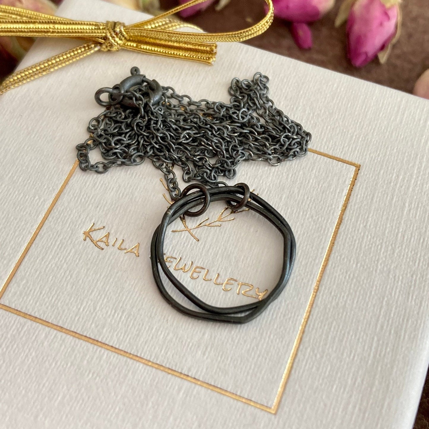 Oxidised sterling silver irregular two interlocking circle necklace.