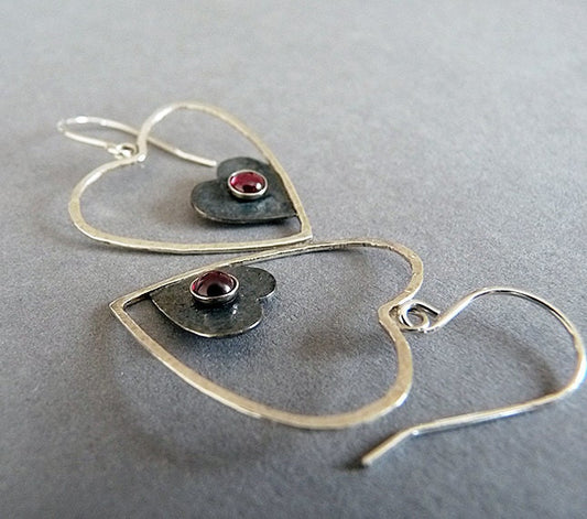 Sterling silver garnet heart earrings.