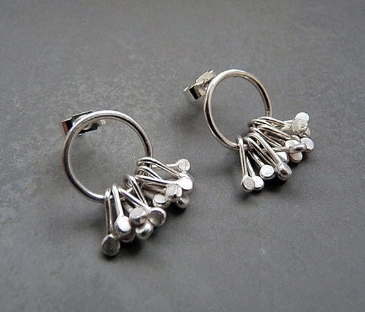 Sterling silver circle and droplets stud earrings.