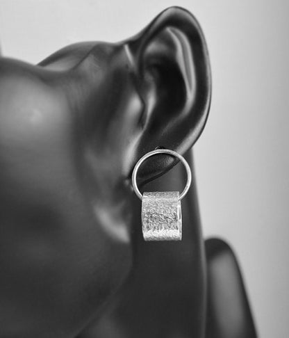 Sterling silver circle stud earrings.