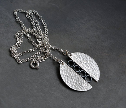 Sterling silver textured circle pendant necklace.